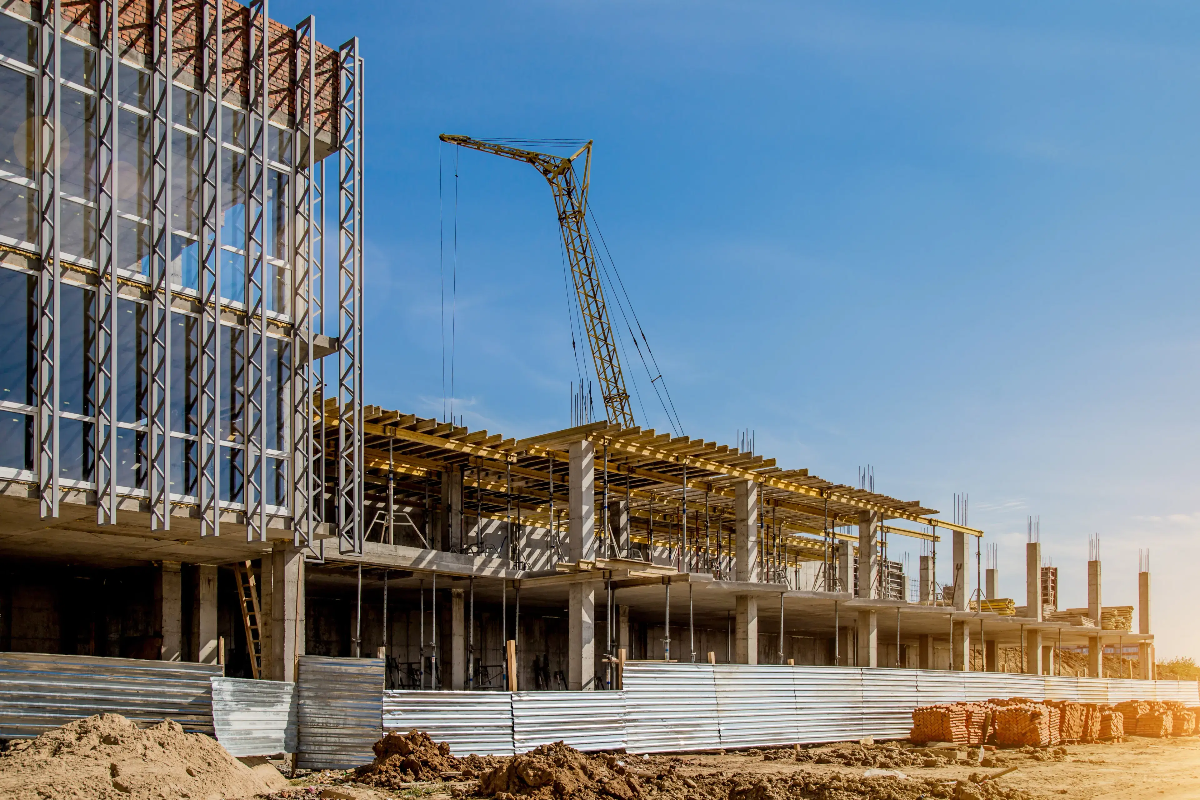 Active construction site with crane and steel framing